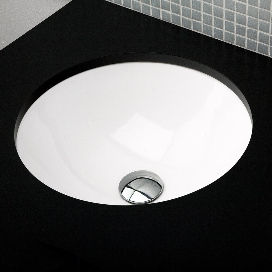 Under-counter porcelain Bathroom Sink with an overflow. Unglazed exterior. DIAM: 17 1/8” H: 7' - Maison&Co.