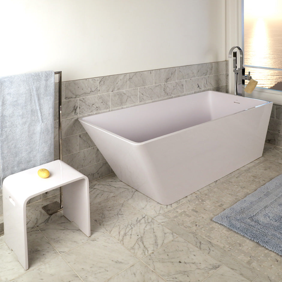 Free-standing soaking bathtub made of white solid surface with an overflow and polished chrome drain, net weight 440lbs, water capacity 112 gal. W: 67", D: 28 3/4", H: 23 5/8".